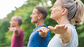 Three people doing yoga.